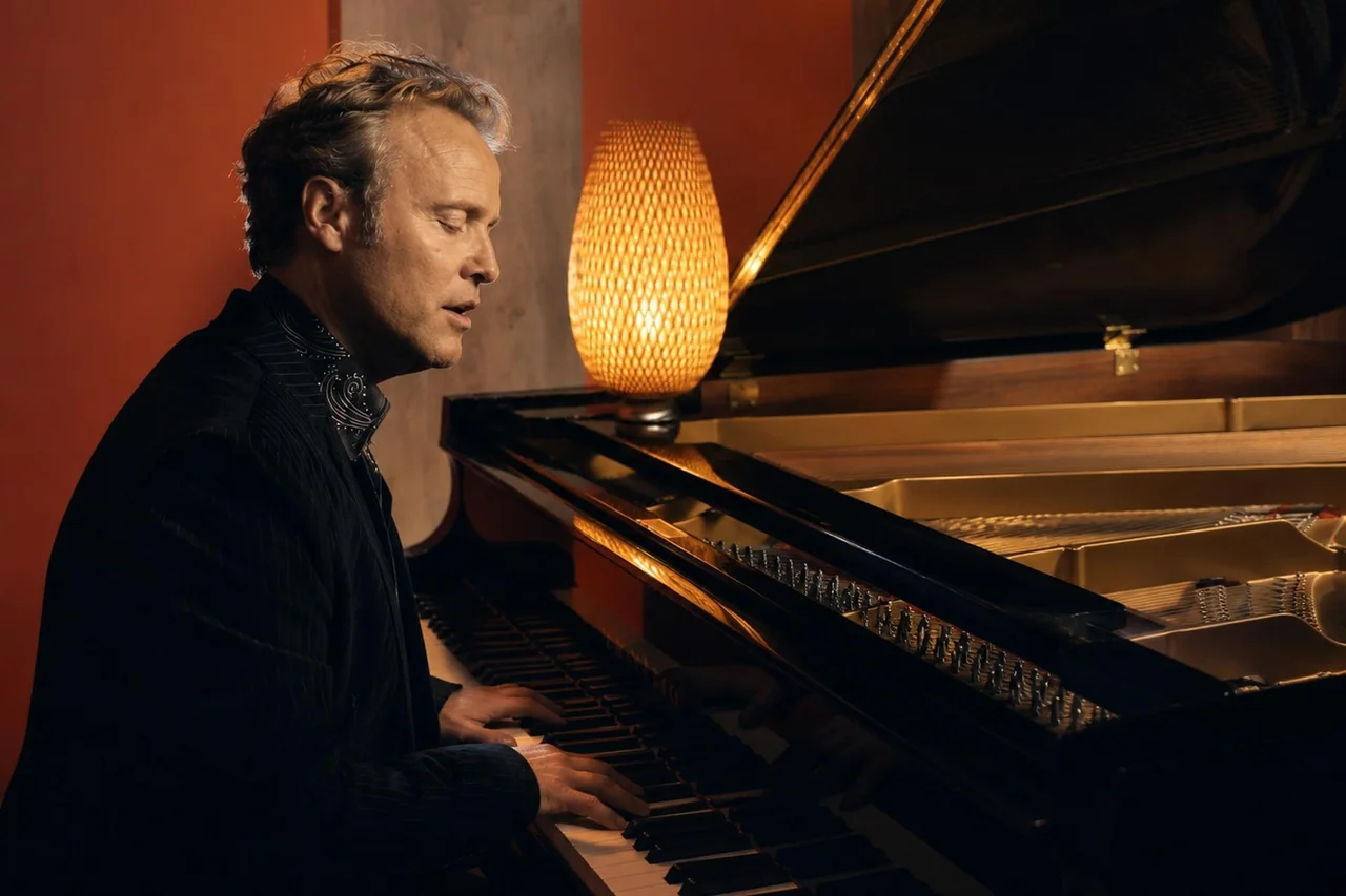 Howard Anderson singing and playing piano in the studio